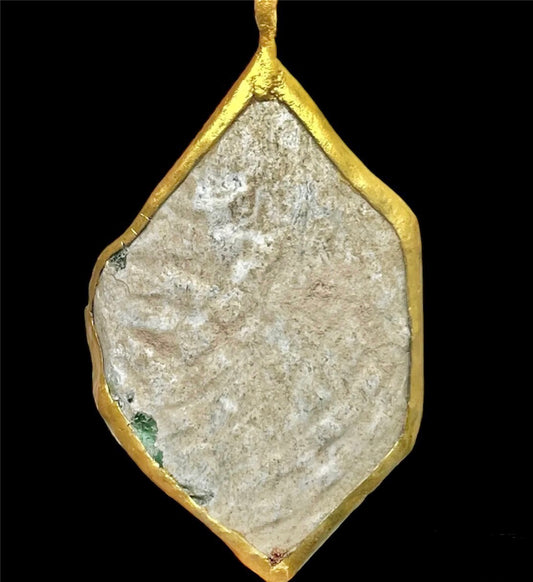 Roman glass fragment mounted in a modern gold-painted frame