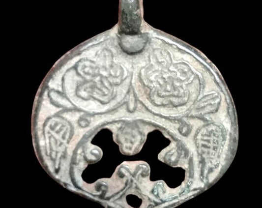 Ancient medieval moon-shaped pendant amulet with floral decorations
